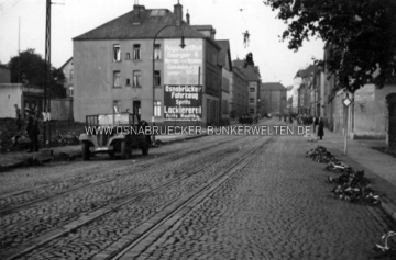 Die Buersche Straße am 19. September 1940 auf Höhe des Kanonenwegs. In der Nacht zuvor stürzte hier am angrenzenden Stahlwerksplatz ein britischer Bomber ab. Eines der Besatzungsmitglieder wurde beim Absturz oder in Folge des Aufpralls in die Oberleitung der Straßenbahn geschleudert und hing dort bis zum nächsten Tag. Auf der Rückseite des Fotos wurde notiert: "Der Pilot hängt tot im Straßenbahndraht". Die Buersche Straße am 19. September 1940