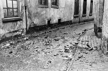 Dachziegel und Trümmer in einer Gasse, vermutlich in der Osnabrücker Altstadt aufgenommen. Wann und wo die Aufnahme entstand, ist unklar. Trümmer in Gasse nach Luftangriff