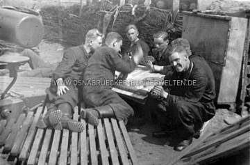 Freizeitbeschäftigung einer Kanonier-Mannschaft in der Flak-Stellung Jeggen. Im Vordergrund links ist ein Kommandogerät zu erkennen. Freizeitbeschäftigung Mannschaft Flak Jeggen